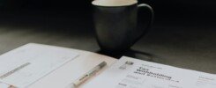 coffee mug near open folder with tax withholding paper